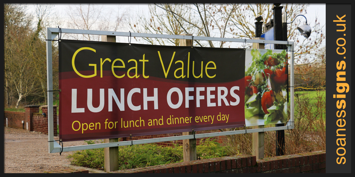 Bespoke aluminium frame on timber posts with printed banner connected with elasticated ties for The Plough restaurant