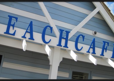 Bespoke shape cut and formed lettering attached to timber beam for Beachcafe sign