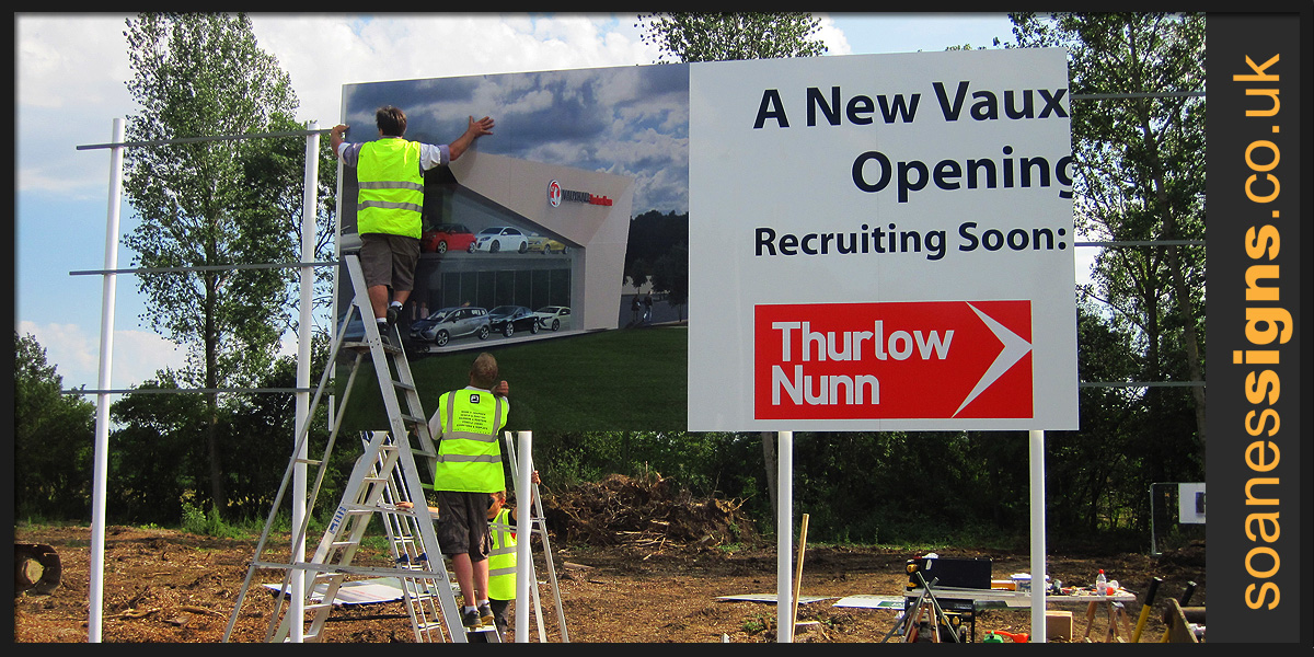 Installation of large panel multi-panel and multi-posted Vauxhall car showroom development sign with printed and applied vinyl graphics