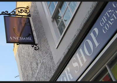 Shop front facia and swinger sign, design and printed graphics of vinyl for The Anchor Shop Blakeney