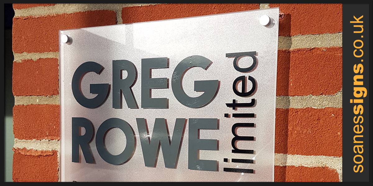 Frosted perspex panel with cut vinyl graphics fitted on metal off-stands for Greg Rowe Ltd
