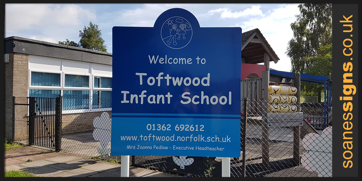 School signs, shape top powder-coated aluminium panel on rails with cut vinyl graphics, installed on aluminium posts for Toftwood Infant School