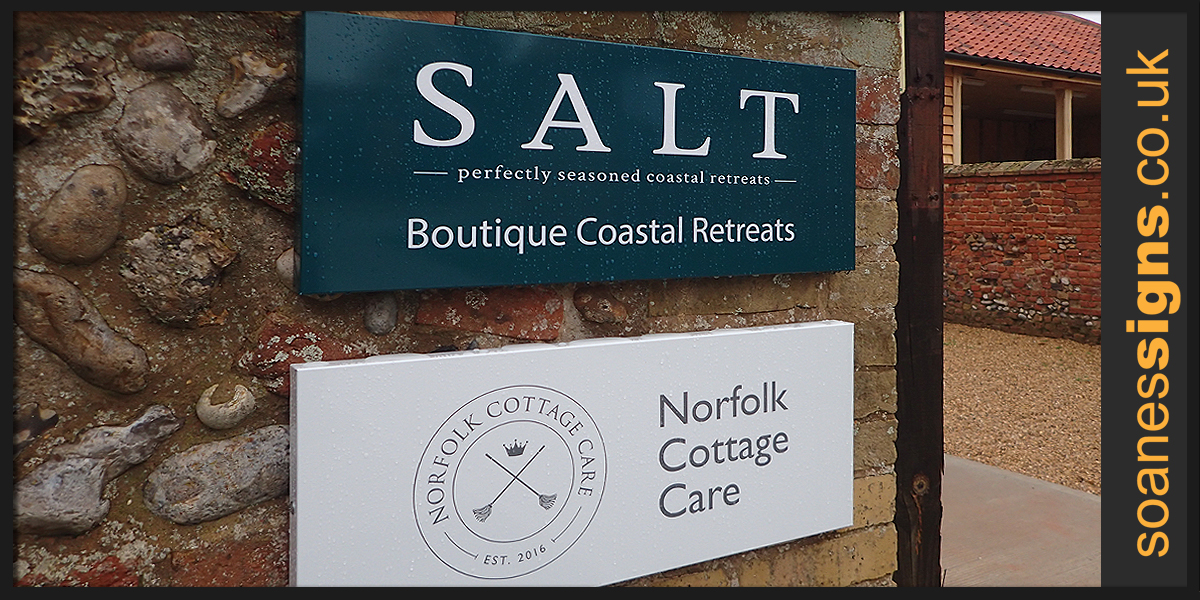 Wall signs from shaped pans with concealed frame and vinyl printed graphics installed for SALT and Norfolk Cottage Care at Holkham Estates