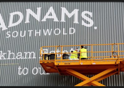 White vinyl graphics applied to corrugated cladding on Hangar Barn for Adnams of Southwold